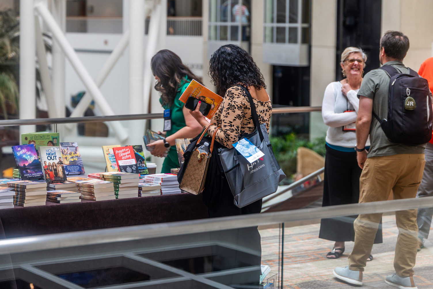 Woman exploring books at an exhibitor stand