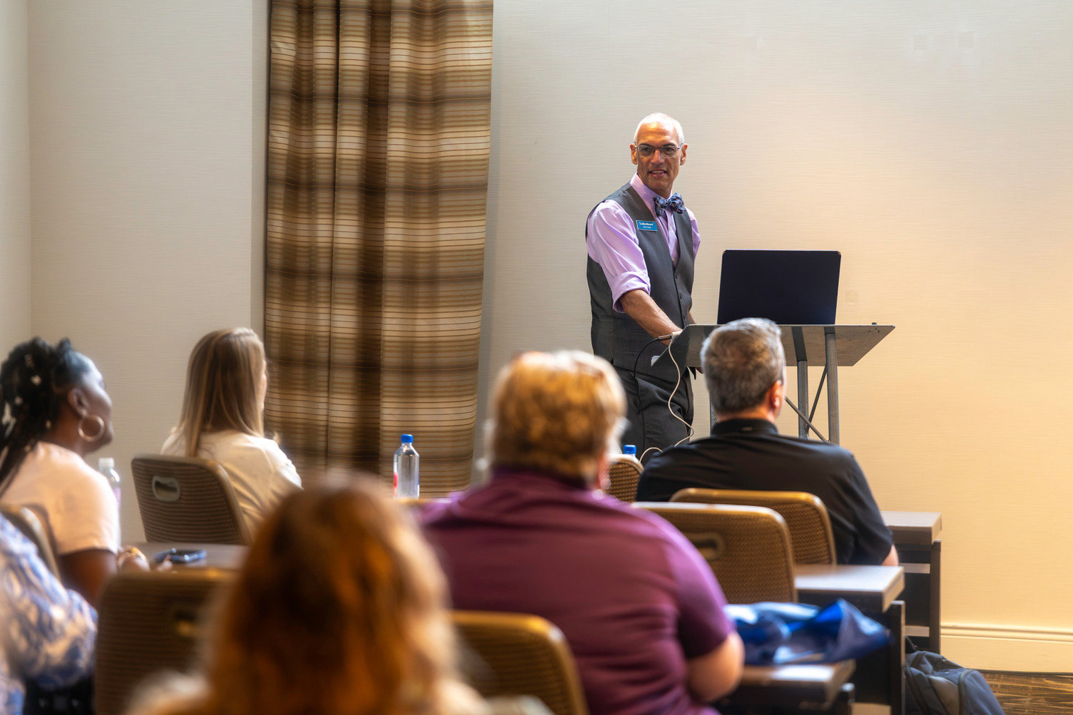 people listening to presenter in a session
